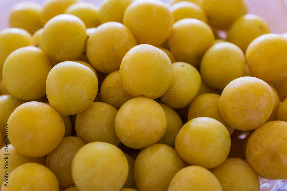 Close up of a bunch of ripe yellow plums. Concept Healthy Eating.