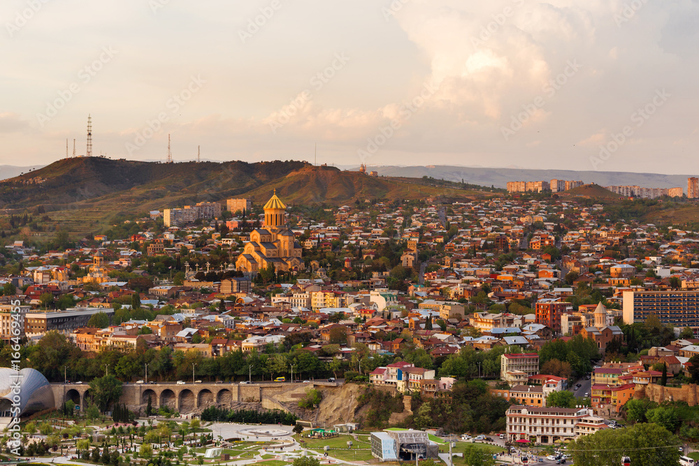 Aerial view on Holy Trinity Cathedral of Tbilisil (Sameba). Sunset view on Tbilisi, Georgia.