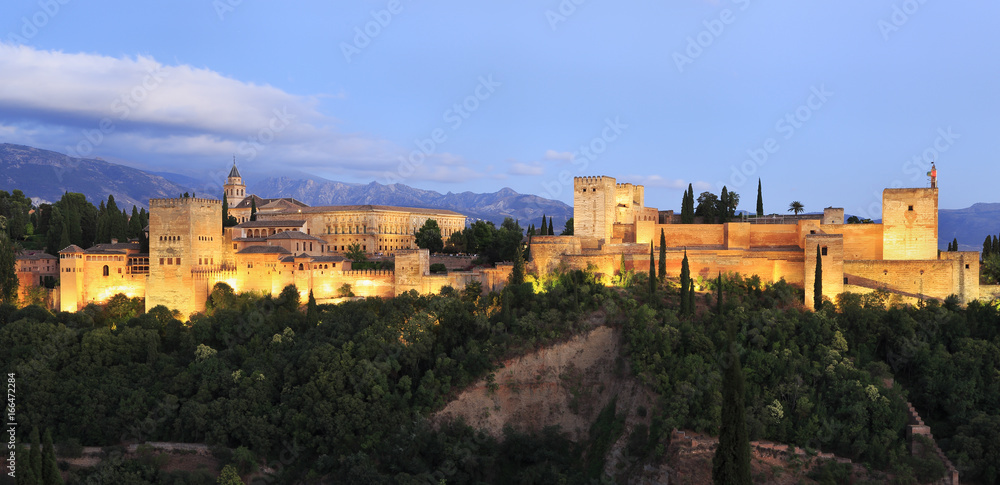 Night photo of the Alhambra Palace illuminated, in Granada, Andalusia, Spain. A monument icon, the most visited in Spain Night photo of the Alhambra Palace illuminated, in Granada, Andalusia, Spain. A monument icon, the most visited in Spain