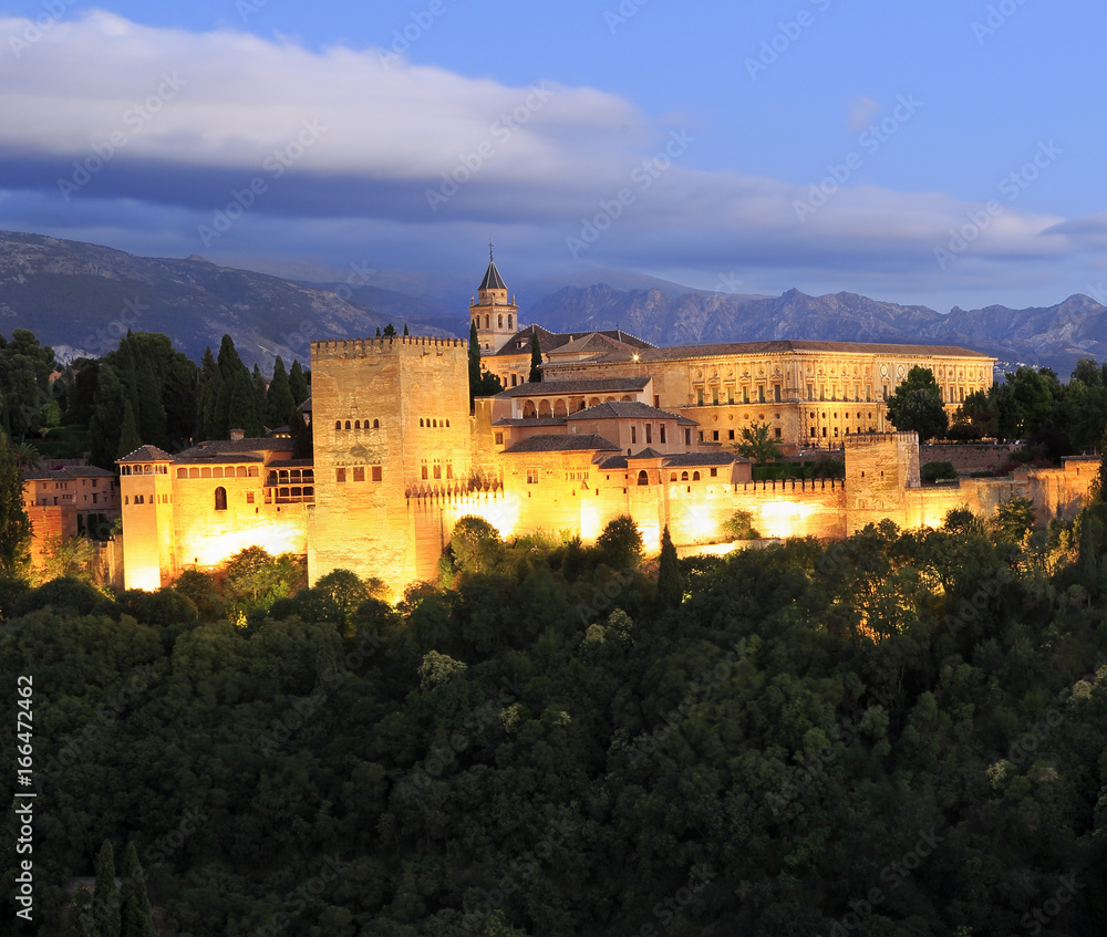 Night photo of the Alhambra Palace illuminated, in Granada, Andalusia, Spain. A monument icon, the most visited in Spain