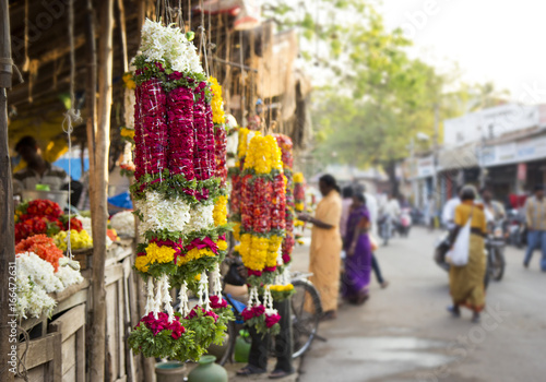 Traditional indian marigold flower garlands in a market place photo