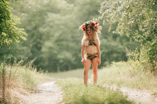 Photography Beautiful little girl in image of nymph dryad stands in forest road