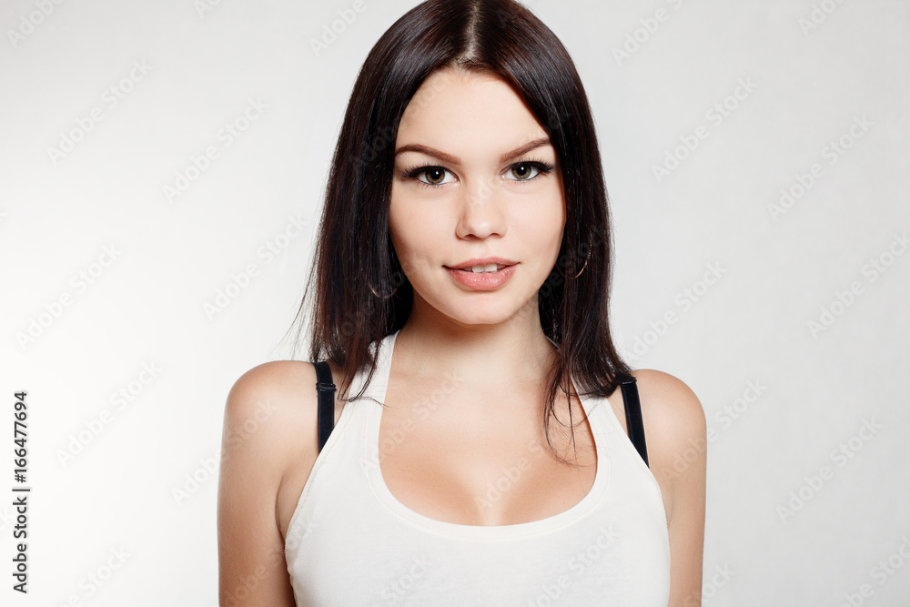 Foto de Beautiful girl with sexy breasts white t-shirt do Stock