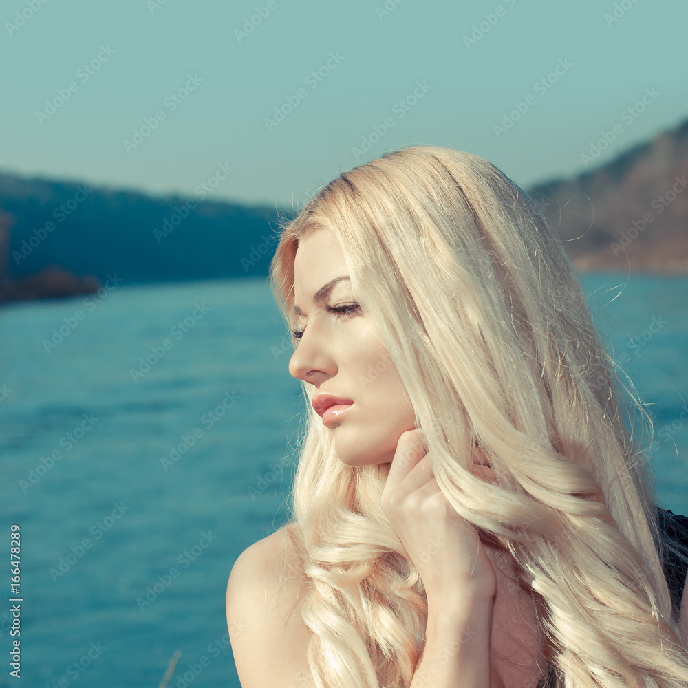 Close portrait of Romantic girl. A sad girl near the water Close portrait of Romantic girl. A sad girl near the water