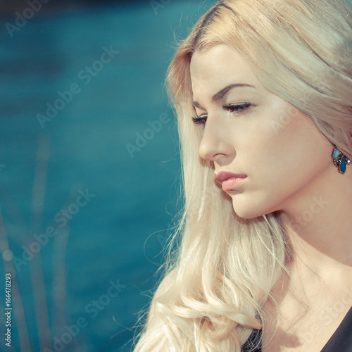 Close portrait of Romantic girl. A sad girl near the water © ruslimonchyk