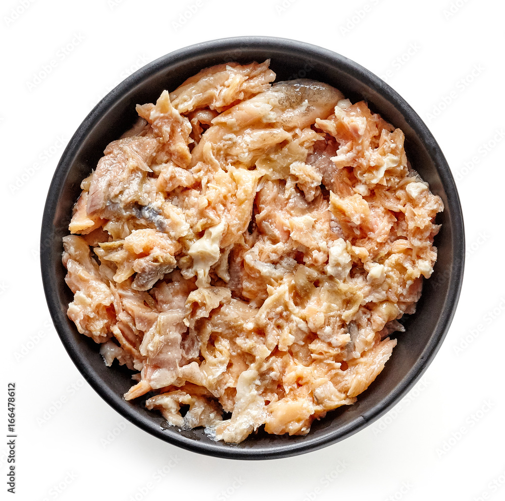 Bowl of canned salmon isolated on white, from above