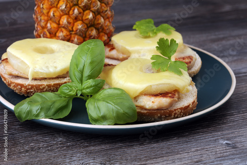 toast hawaii, , cheese and pineapple on wooden background with chicken breast