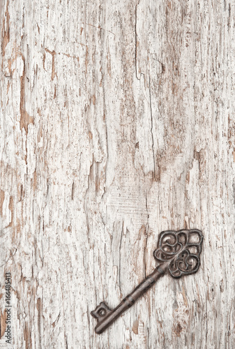 Vintage background with old key on wood