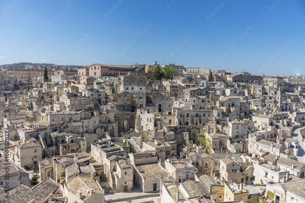 amazing panorama view of ancient ghost town of Matera (Sassi di Matera) in bright sun shine summer with blue sky, south Italy
