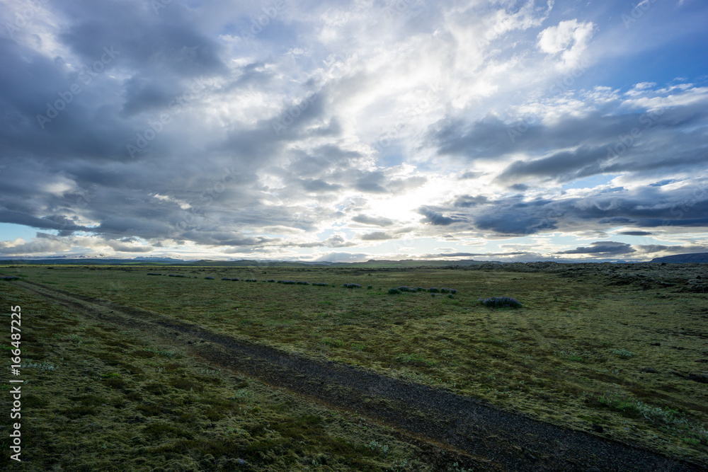 Iceland - Wide green landscape with intense cloud formation at dawn