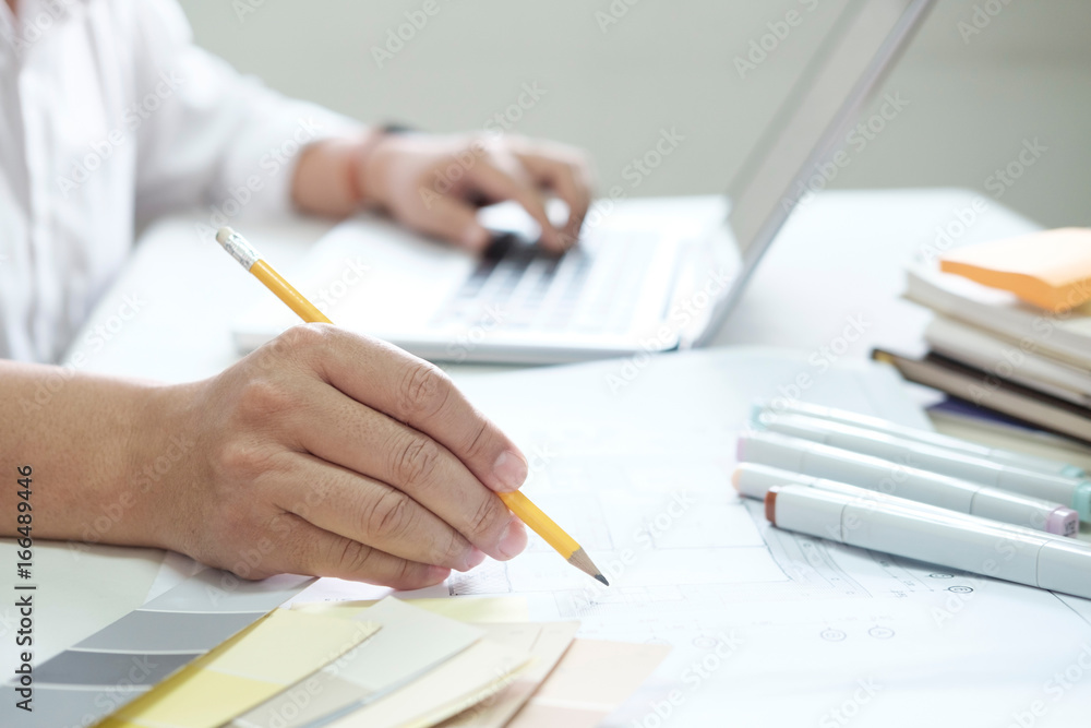 Graphic design and color swatches and pens on a desk. Architectural drawing with work tools and accessories. Graphic design and color swatches and pens on a desk. Architectural drawing with work tools and accessories.