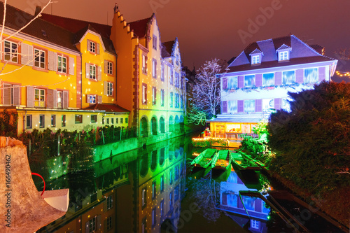 Traditional Alsatian half-timbered houses and river Lauch in Petite Venise or little Venice, old town of Colmar, decorated and illuminated at christmas time, Alsace, France