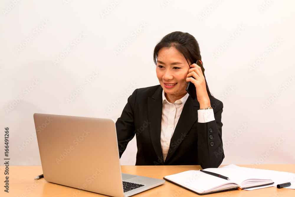 Asian woman call and check data from laptop Asian woman call and check data from laptop