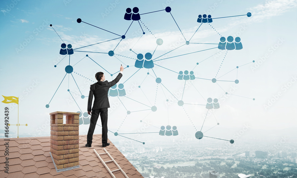 Businessman on house roof presenting networking and connection concept. Mixed media Businessman on house roof presenting networking and connection concept. Mixed media