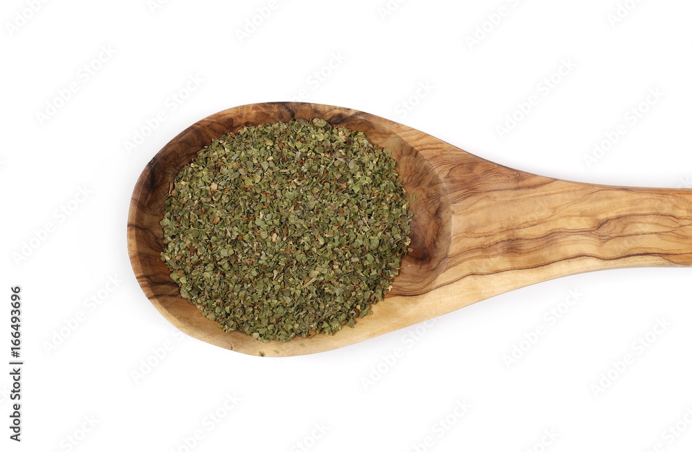 Dry marjoram in wooden spoon isolated on white background, top view Dry marjoram in wooden spoon isolated on white background, top view
