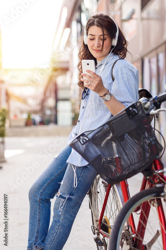 Beautiful young woman with bicycle in urban environment. © Zoran Zeremski