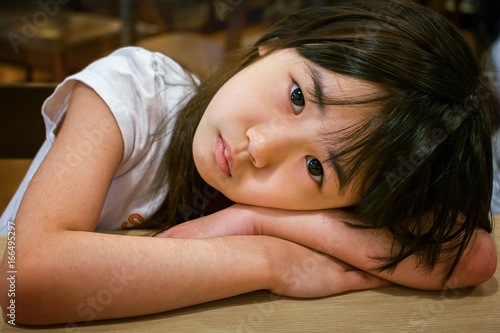 Fotografie Little Girl with Head down on the table