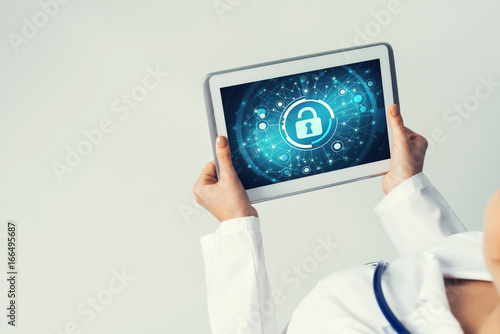 Close of female doctor hands working with tablet pc computer