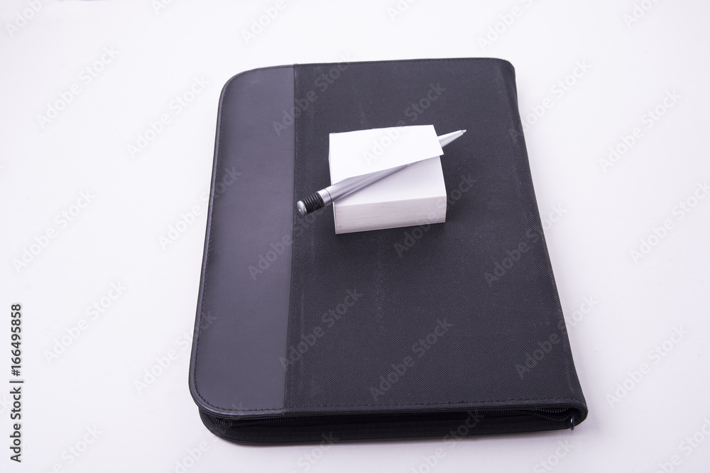 Closed notepad carrying case with paper and pen in white Closed notepad carrying case with paper and pen in white
