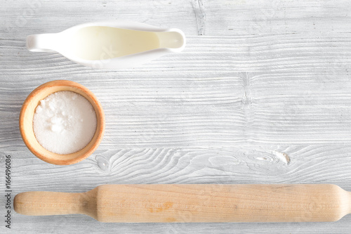 Put the dough. Flour and rolling pin on light wooden table background top view copyspace