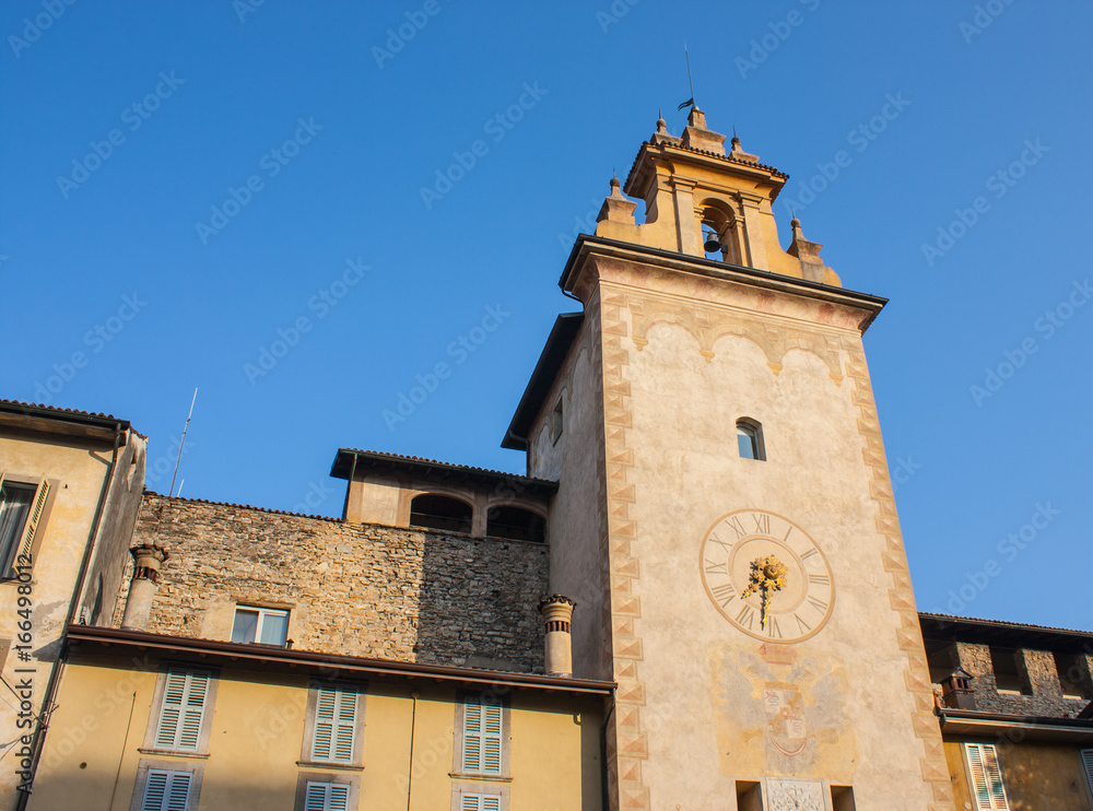 Bergamo - Old city. One of the beautiful city in Italy. Lombardy. The clock tower close to Roncalli historical building during a wonderful blue sky