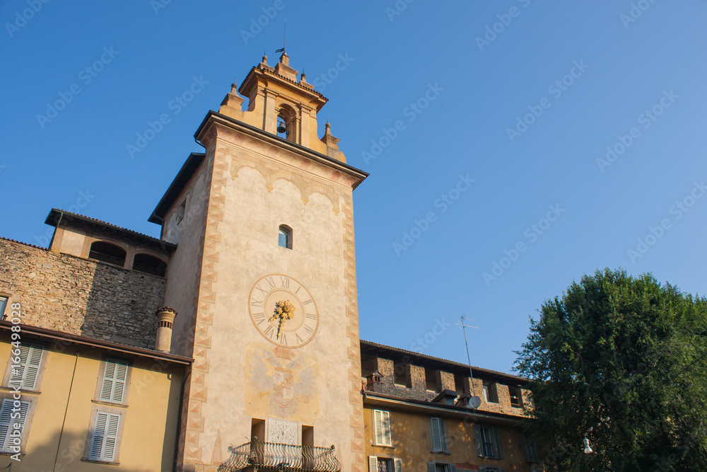 Bergamo - Old city. One of the beautiful city in Italy. Lombardy. The clock tower close to Roncalli historical building during a wonderful blue sky