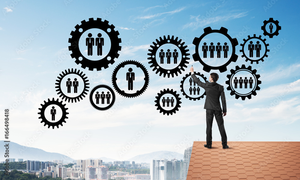 Businessman on house roof presenting teamwork and connection concept. Mixed media Businessman on house roof presenting teamwork and connection concept. Mixed media