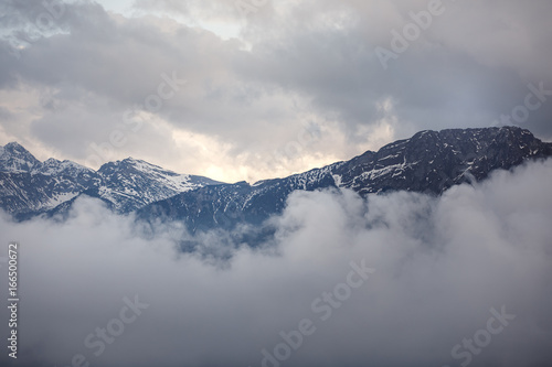 Mountain peaks in clouds © annaav