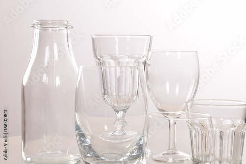 Empty crystal glasses and glasses and a bottle