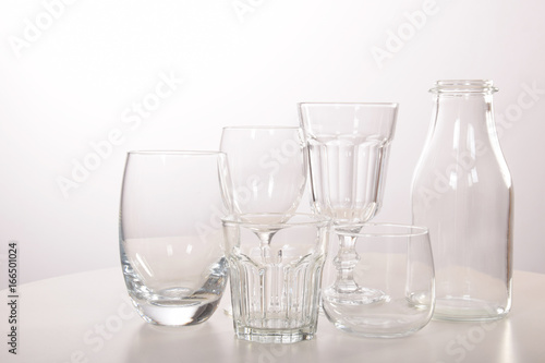 Empty crystal glasses and glasses and a bottle