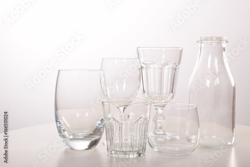 Empty crystal glasses and glasses and a bottle