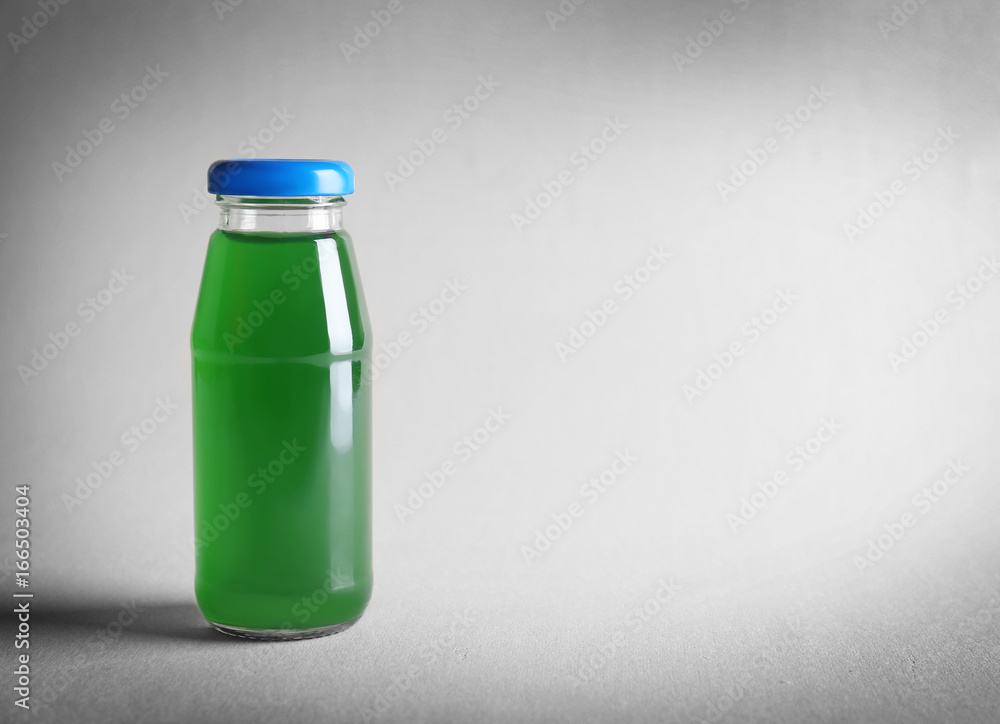 Delicious juice in bottle on light background Delicious juice in bottle on light background