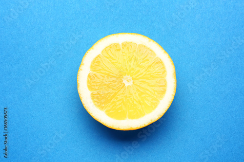Half of delicious fresh lemon on color background