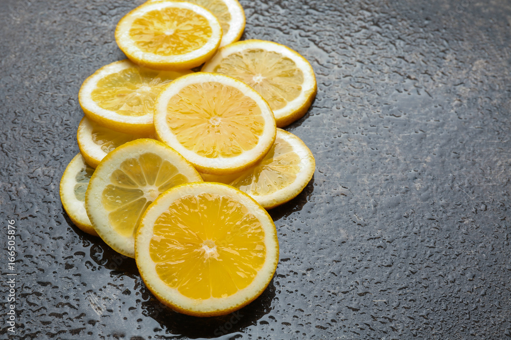 Delicious sliced lemon on dark background Delicious sliced lemon on dark background