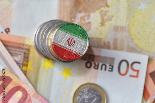 euro coin with national flag of iran on the euro money banknotes background.