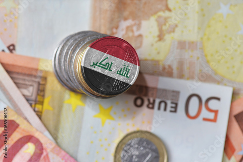euro coin with national flag of iraq on the euro money banknotes background.