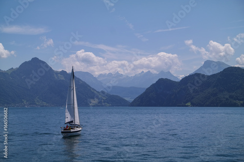 Sailing boat on luzern sea in front of mountains