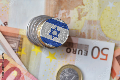 euro coin with national flag of israel on the euro money banknotes background.