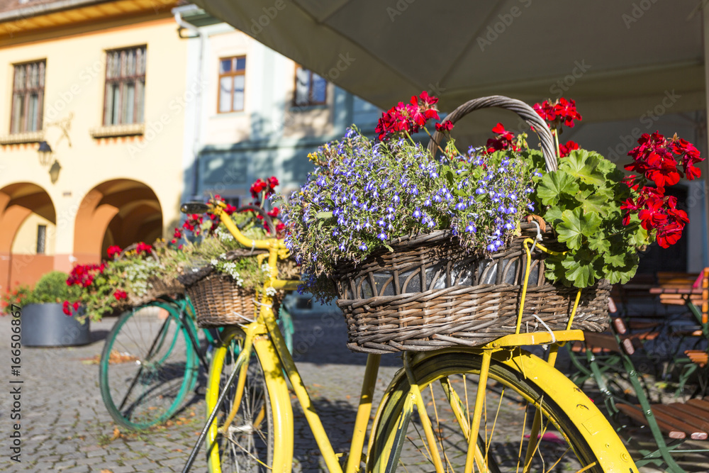 Bicycle with flower basket on the street of Sighisoara in Romania