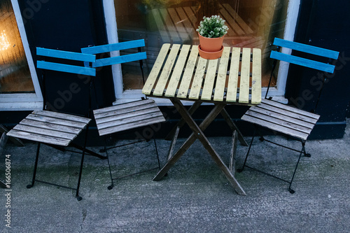 Wooden chairs and table standing outside a cafe photo