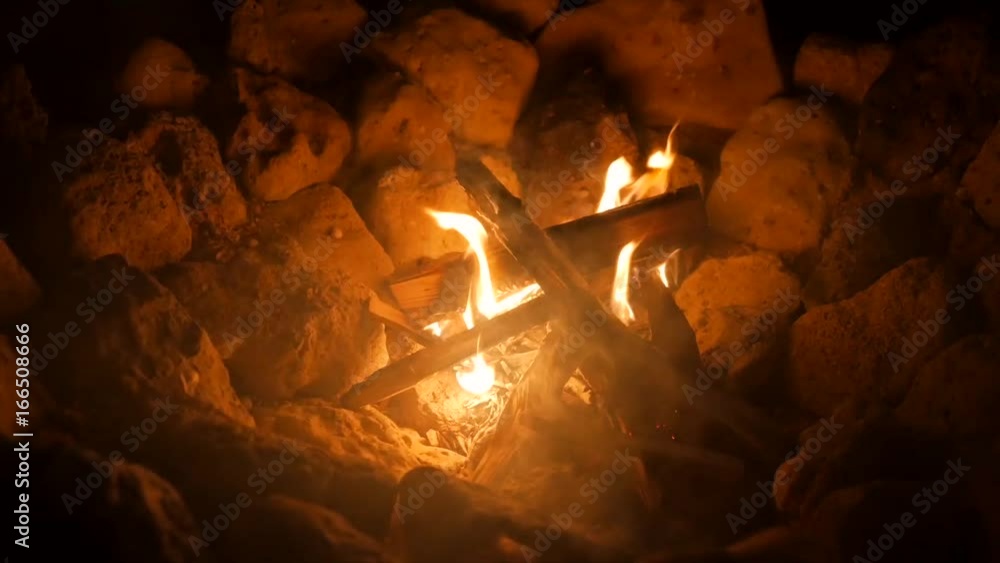 Stunning Burning Camp Fire in a Pit Lined with Rocks. HD Stunning Burning Camp Fire in a Pit Lined with Rocks. HD