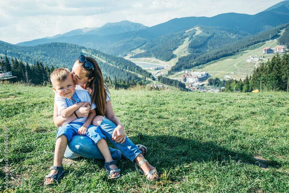 mother with son on her knees sit on the top of the mountains mother with son on her knees sit on the top of the mountains