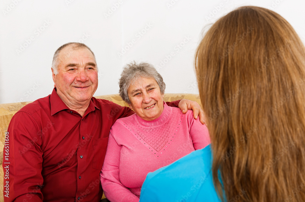 Happy elderly couple and young caregiver Happy elderly couple and young caregiver