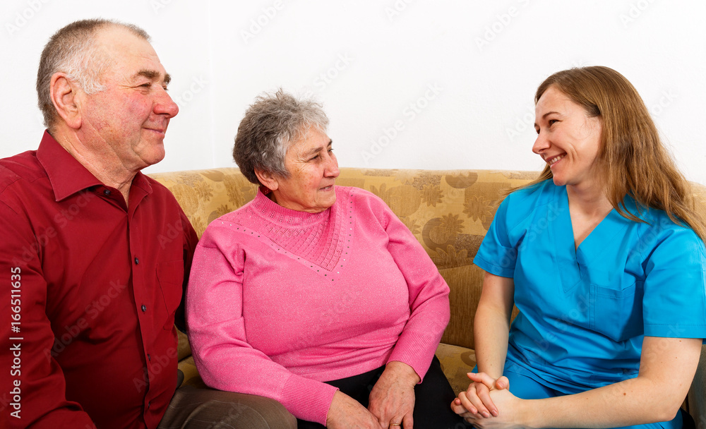 Happy elderly couple and young caregiver Happy elderly couple and young caregiver