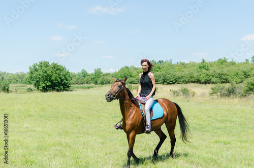 happy smiling woman riding horse