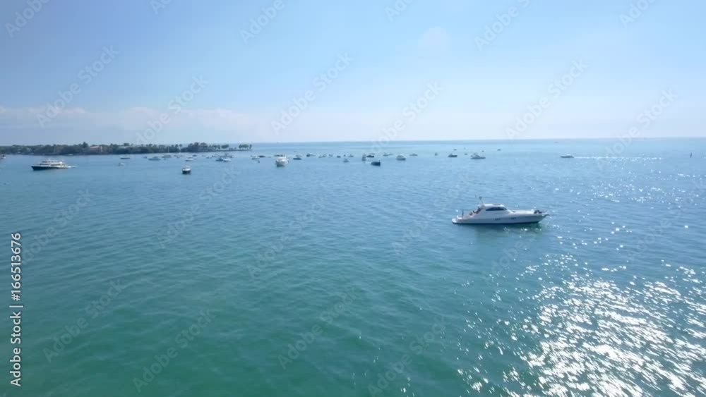 Beautiful aerial shot of boats parked on the ocean on a sunny day Beautiful aerial shot of boats parked on the ocean on a sunny day