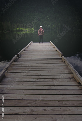 Man Standing At End of Dock