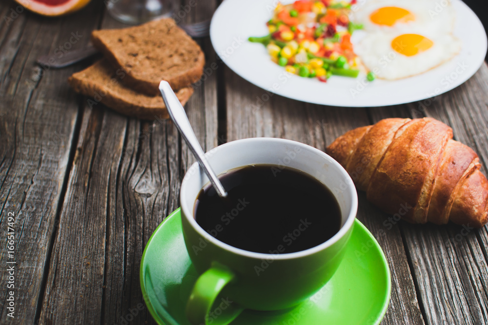 Coffee in a green mug on wooden surface Coffee in a green mug on wooden surface
