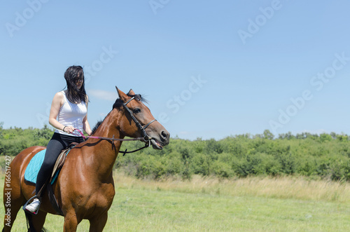 woman jockey training the horse on field