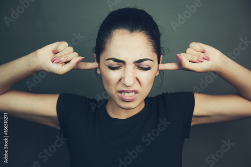 Schilderij op canvas Angry woman plugging her ears with fingers